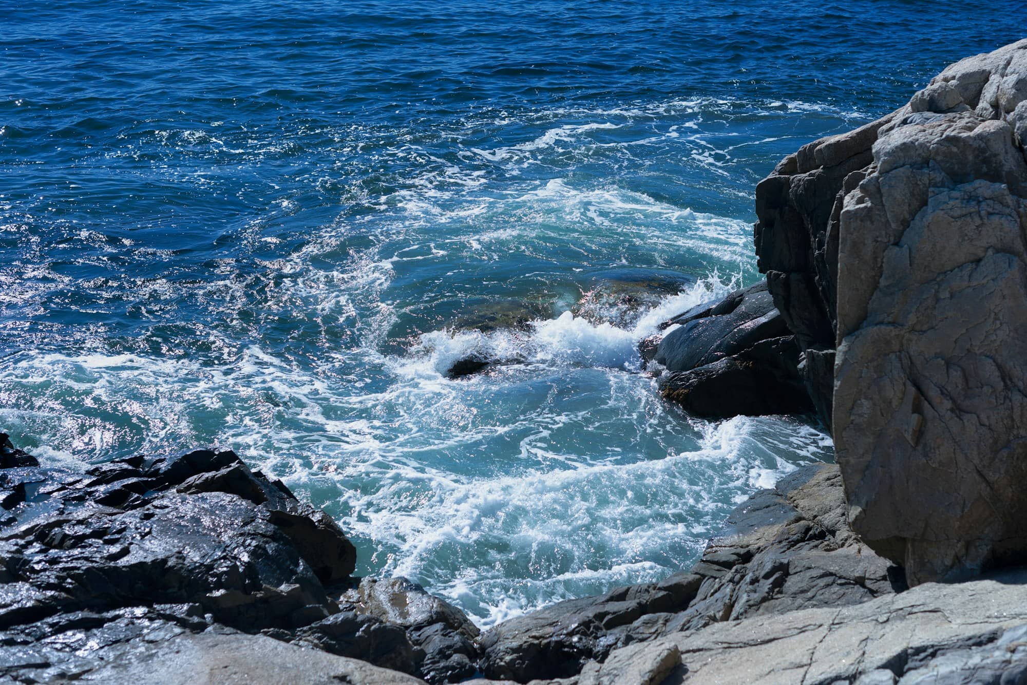 a body of water surrounded by rocks and water