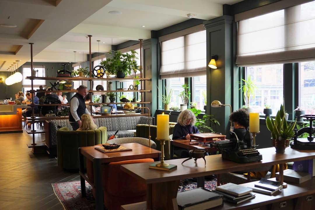 People relaxing in a stylish, plant-filled lounge area.