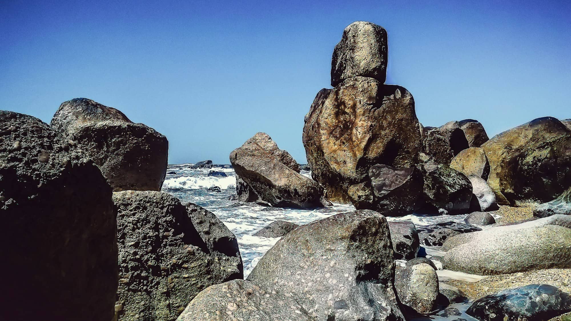 rock formations beside body of water at daytime