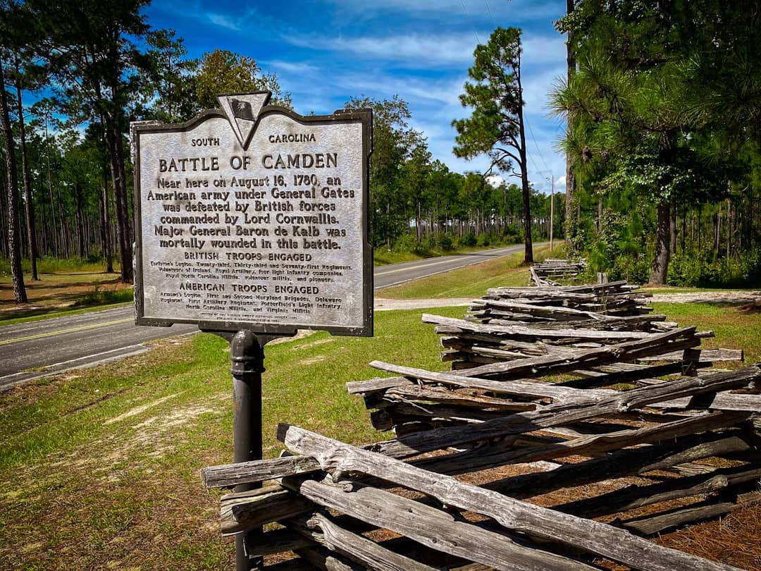 Battle of camden historical marker with wooden fence