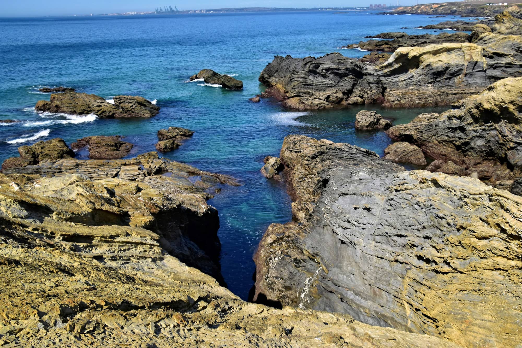 Rocky coastline with clear blue ocean water.