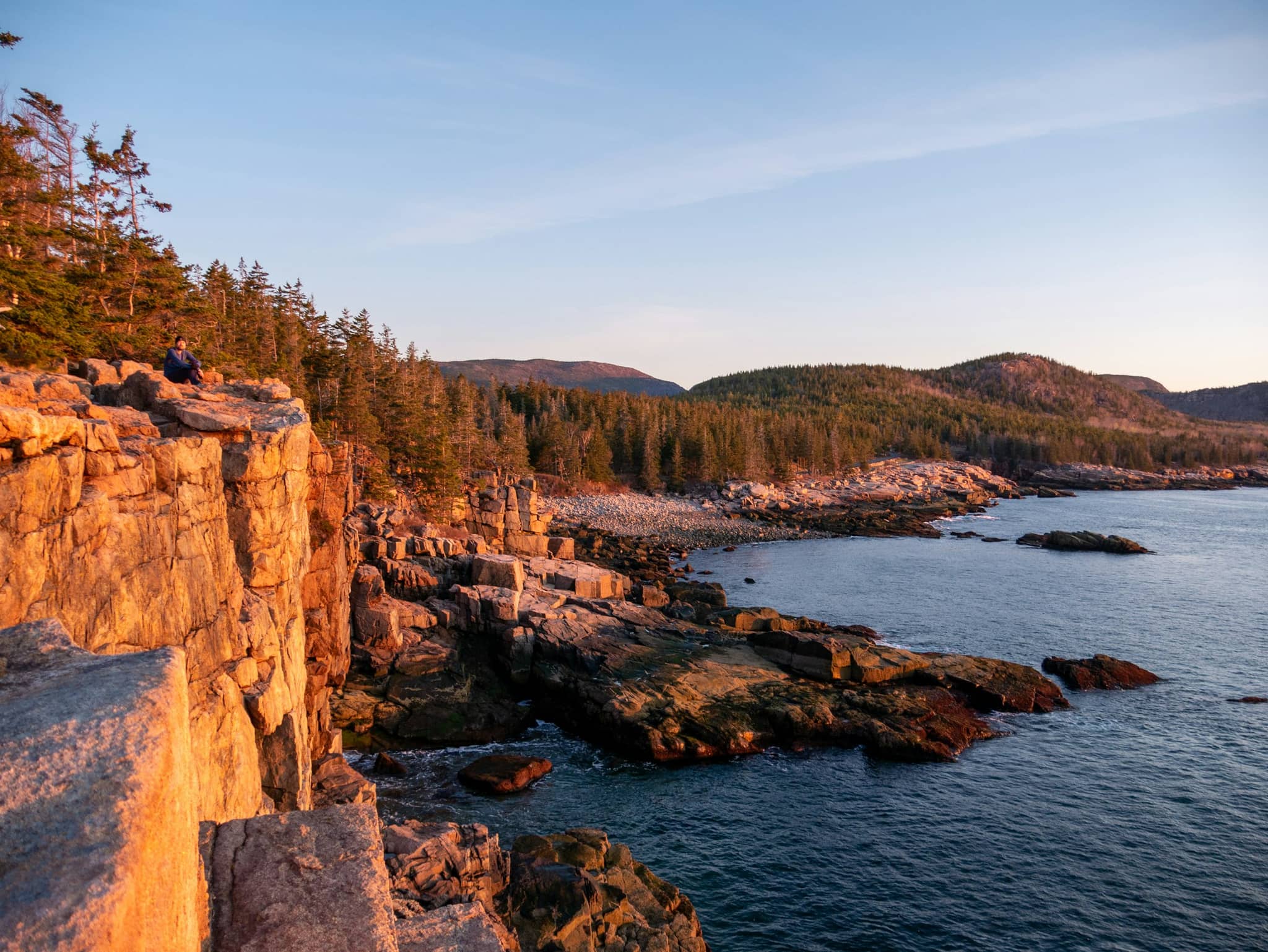 A granite cliff dropping to open water on the Maine coast
