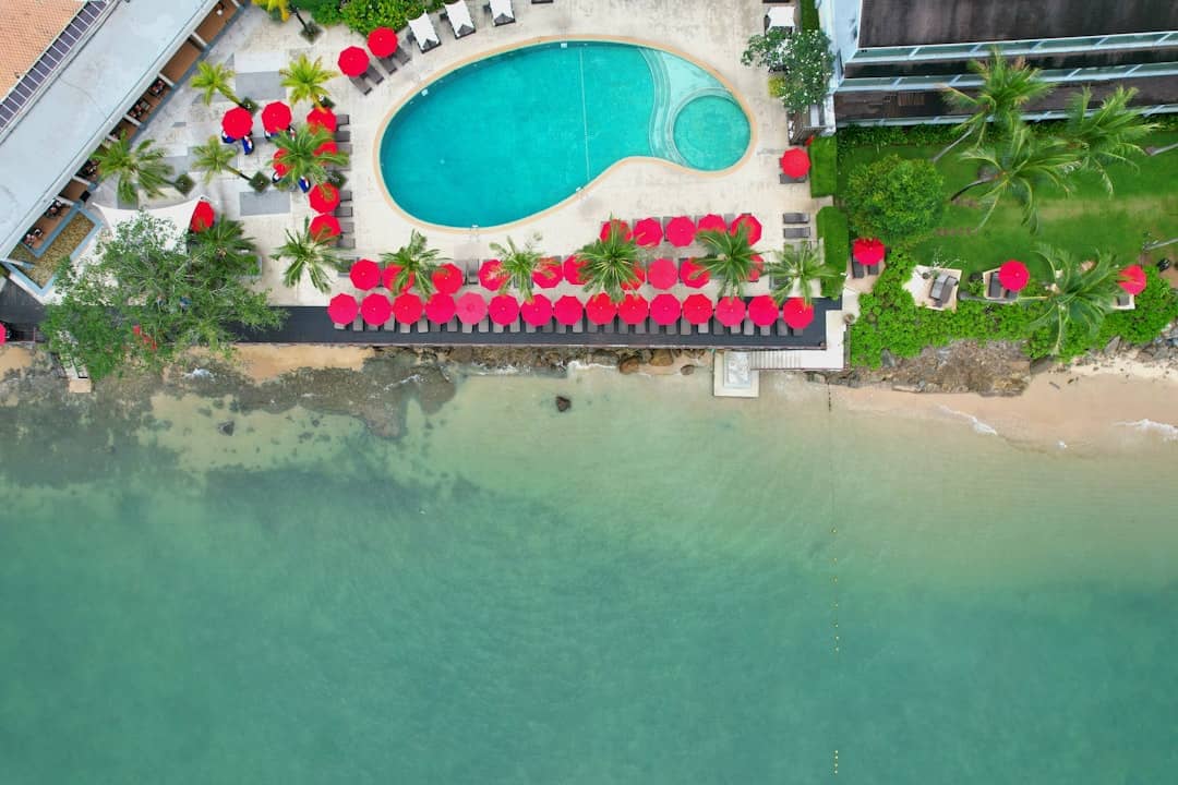 Resort with pool and beach chairs by the ocean