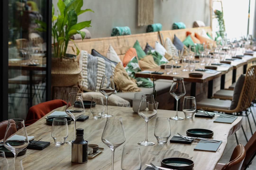 a long table with wine glasses and place settings