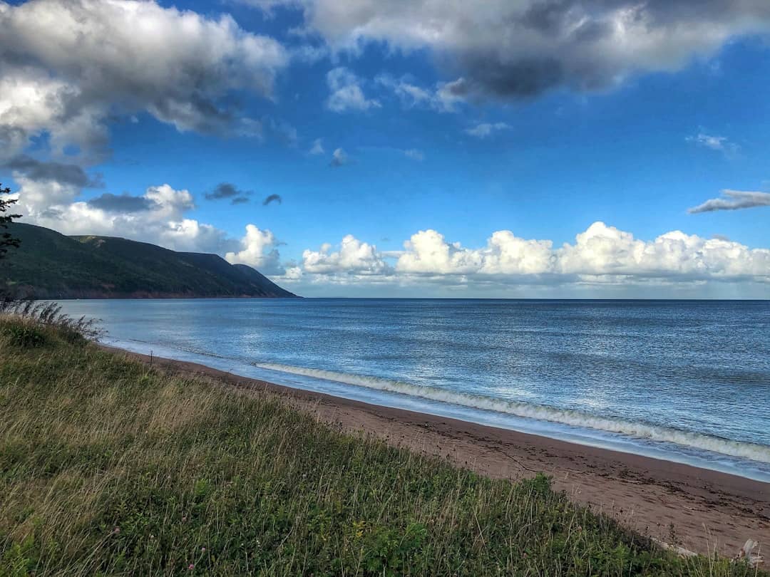 a view of the ocean from the shore of a beach