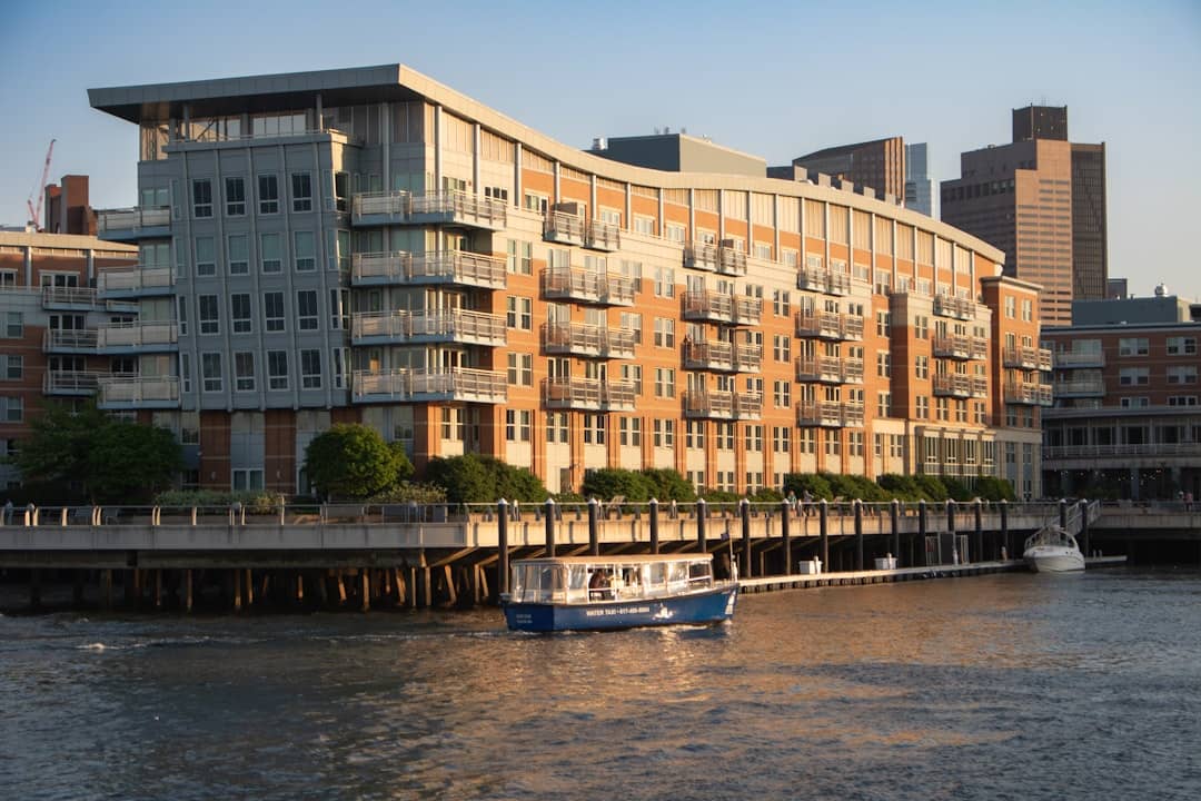 a boat in a body of water near a large building