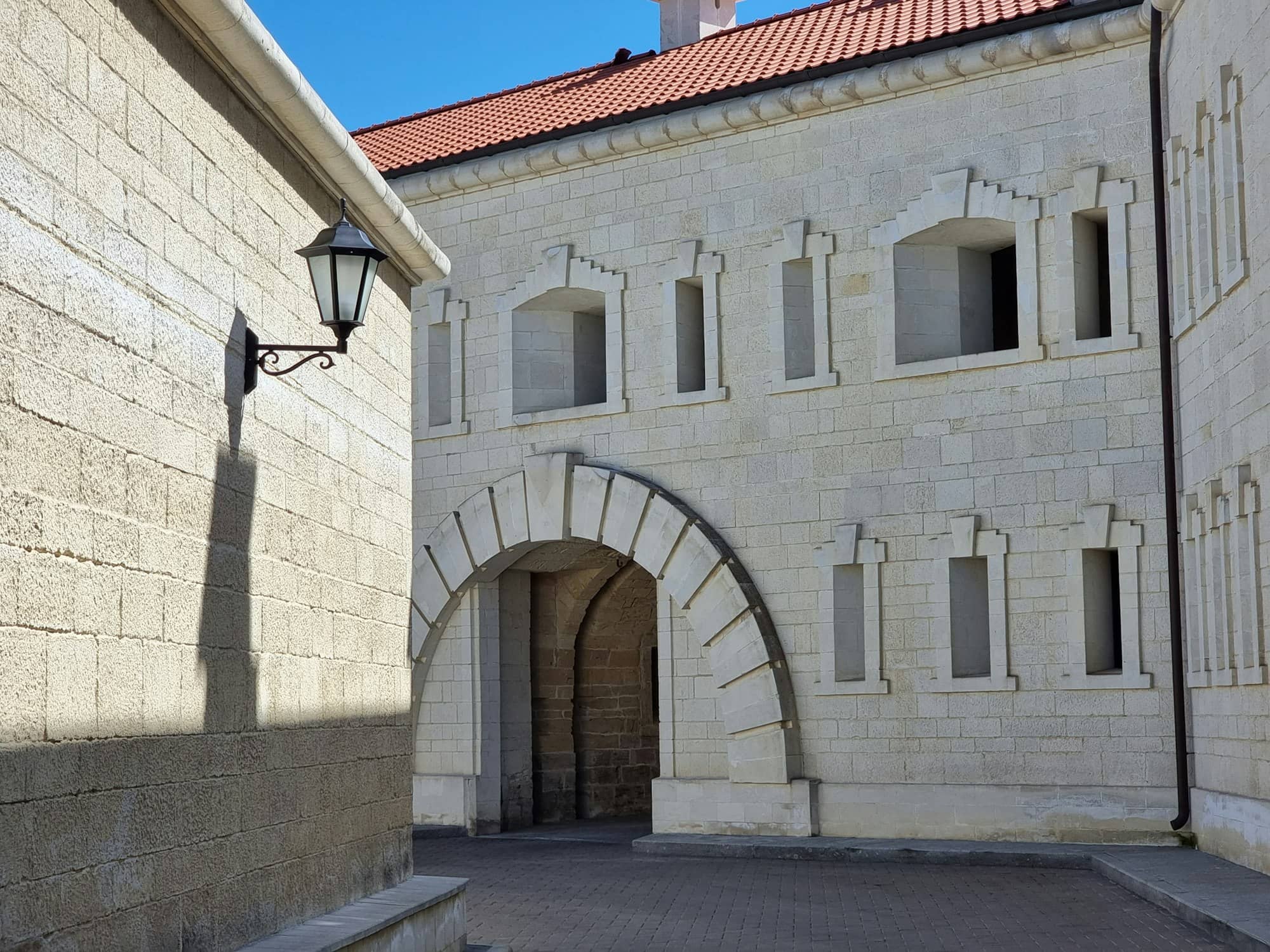 a stone building with a brick archway