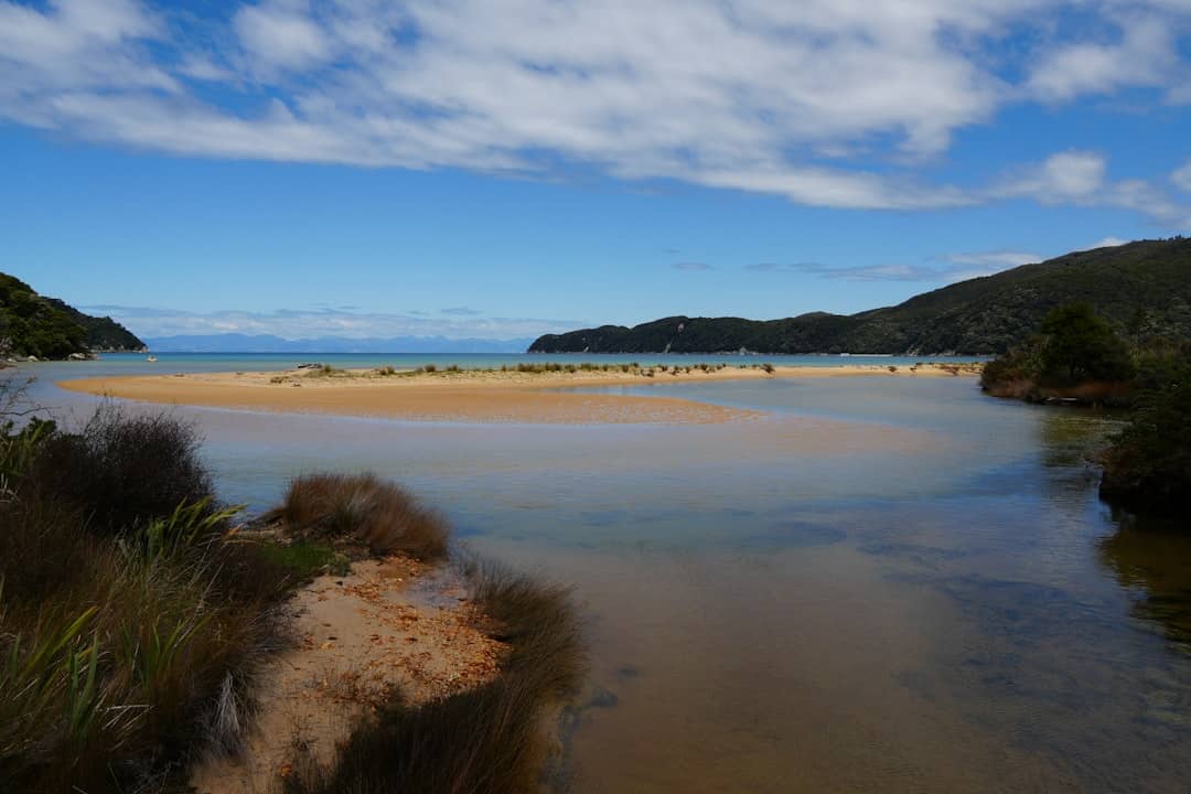 a body of water surrounded by a sandy beach