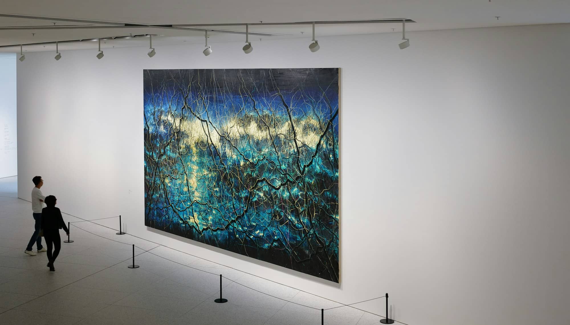a large painting hanging on the wall of a museum