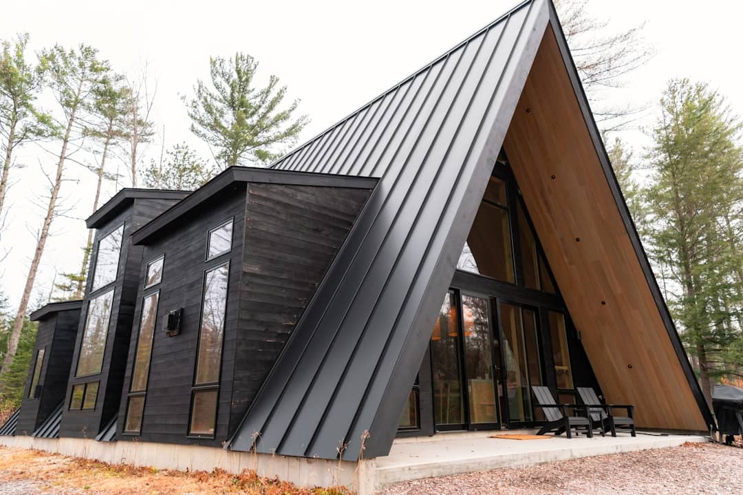 A house with a triangular roof made of wood and metal