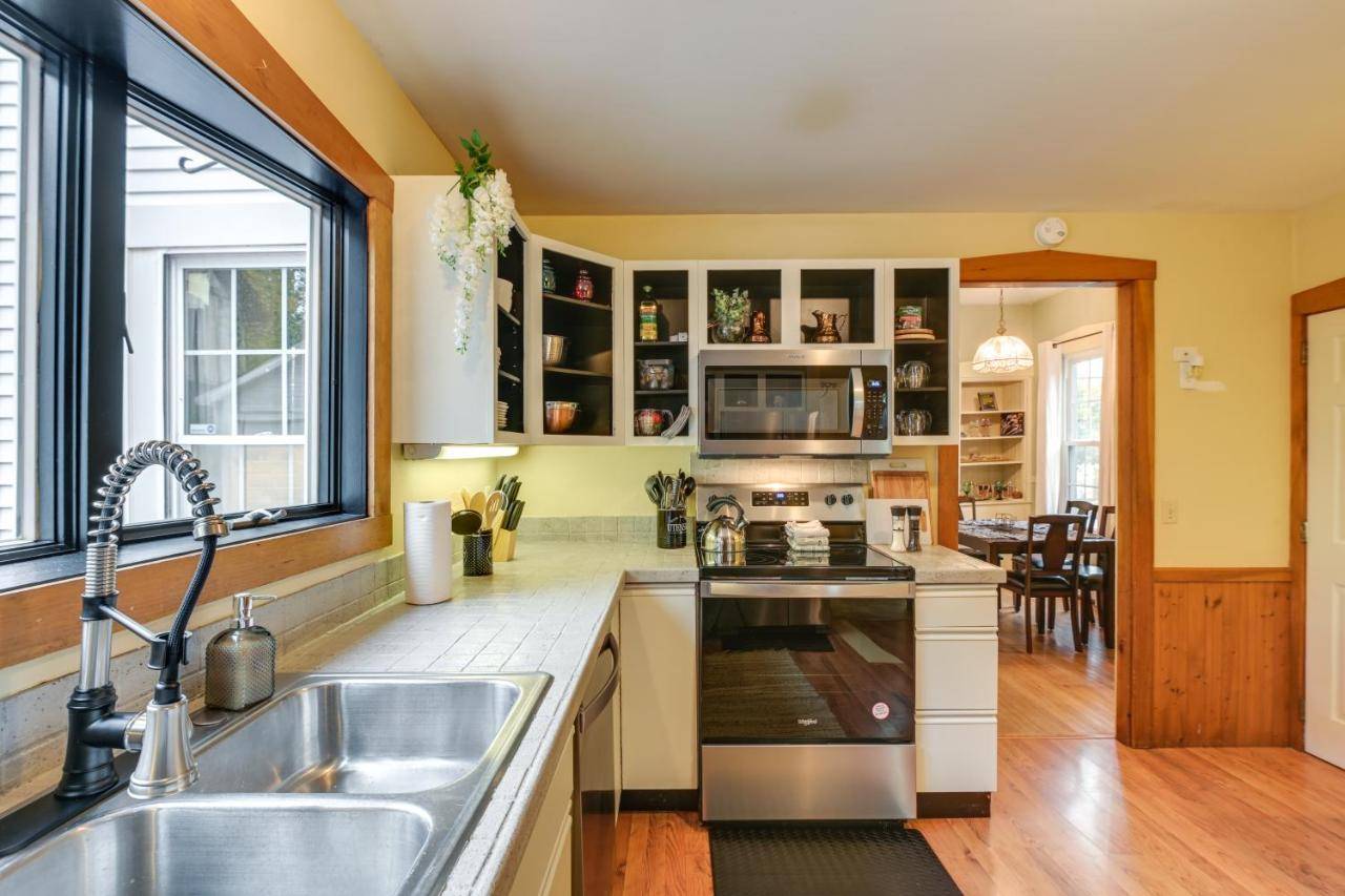 a kitchen with a sink and a stove at Charming Bangor Home with Deck Less Than 1 Mi to Downtown in Bangor