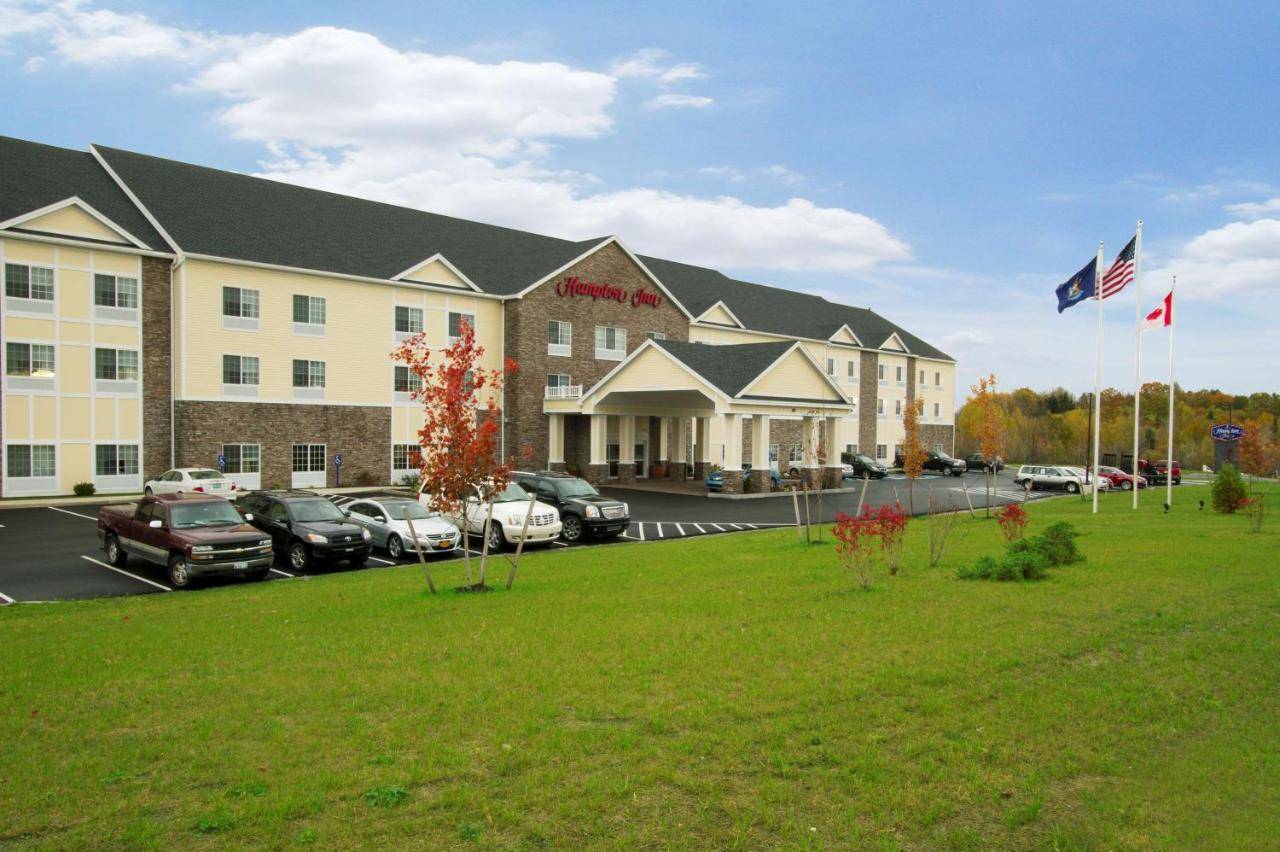 a hotel with cars parked in a parking lot at Hampton Inn Bangor in Bangor