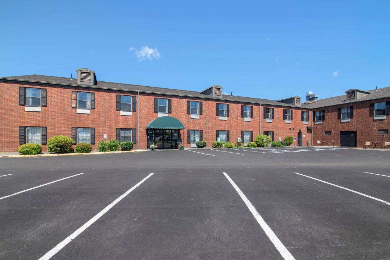 an empty parking lot in front of a large brick building at Quality Inn at Bangor Mall in Bangor