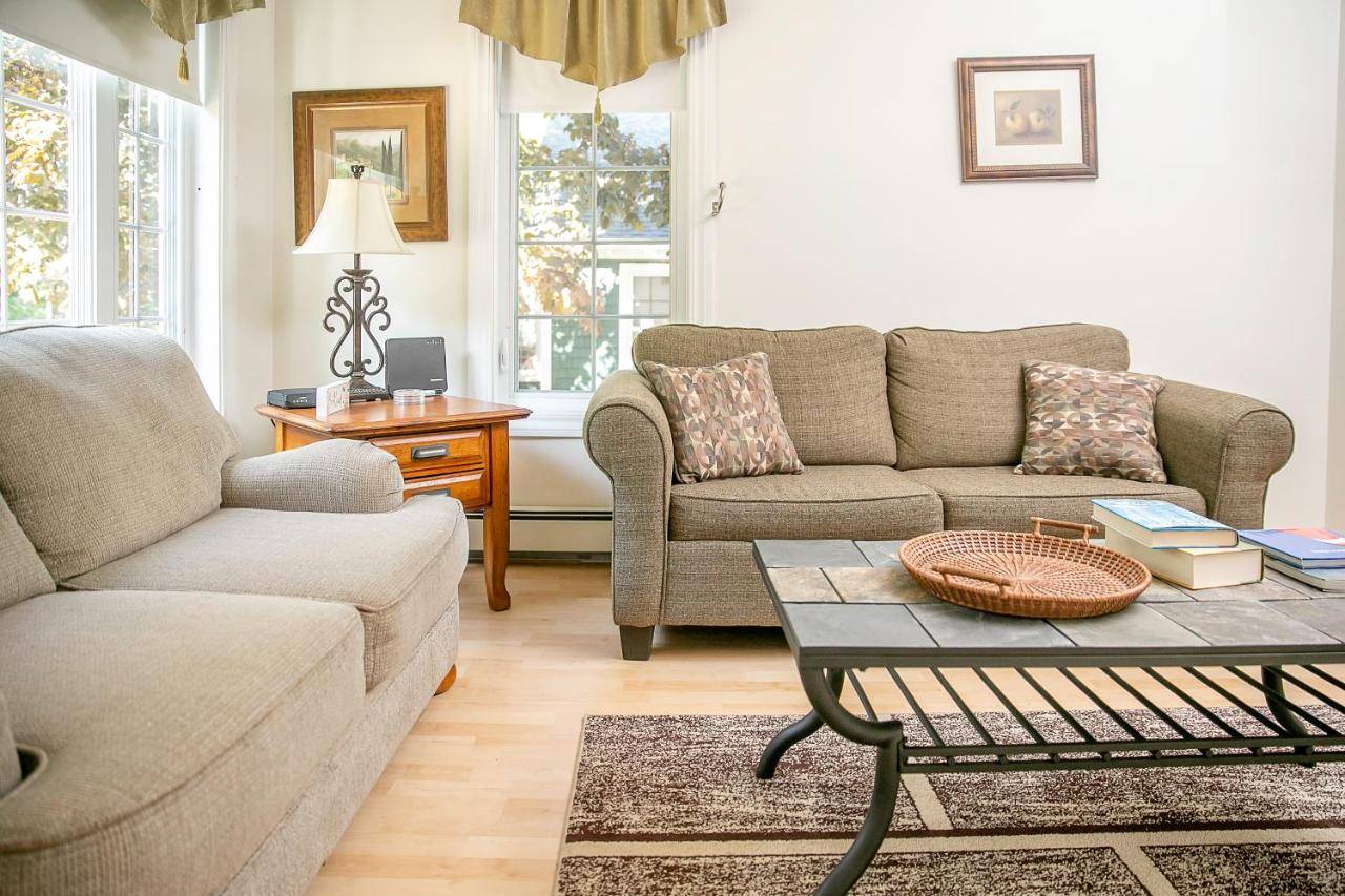 a living room with two couches and a coffee table at Aspen Cottage in Bar Harbor