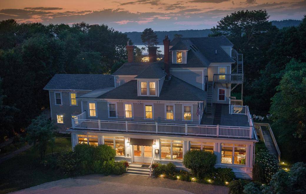 a large house with its lights on at night at Bass Cottage & Ullikana in Bar Harbor