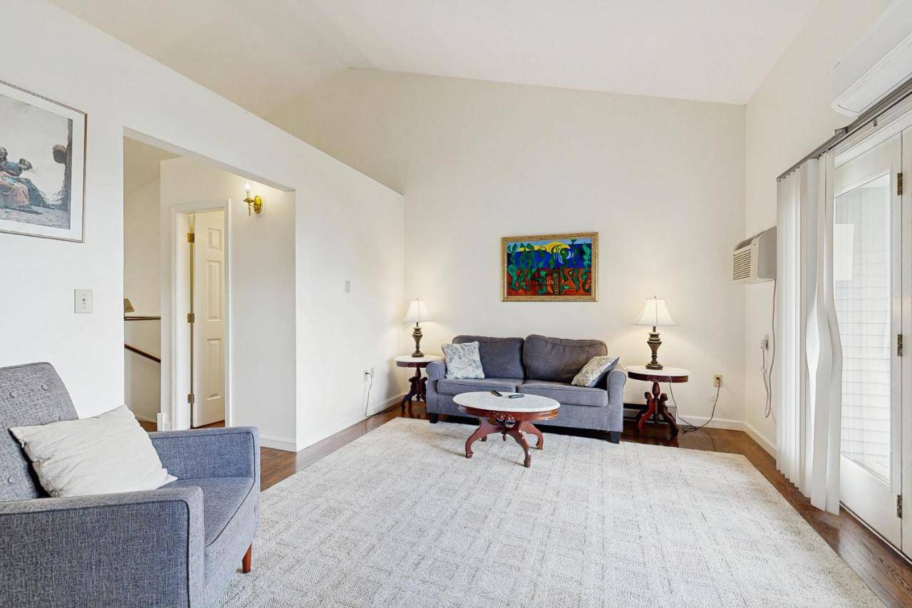 a living room with a couch and a table at Birch Tree Lane - Unit 313 in Bar Harbor