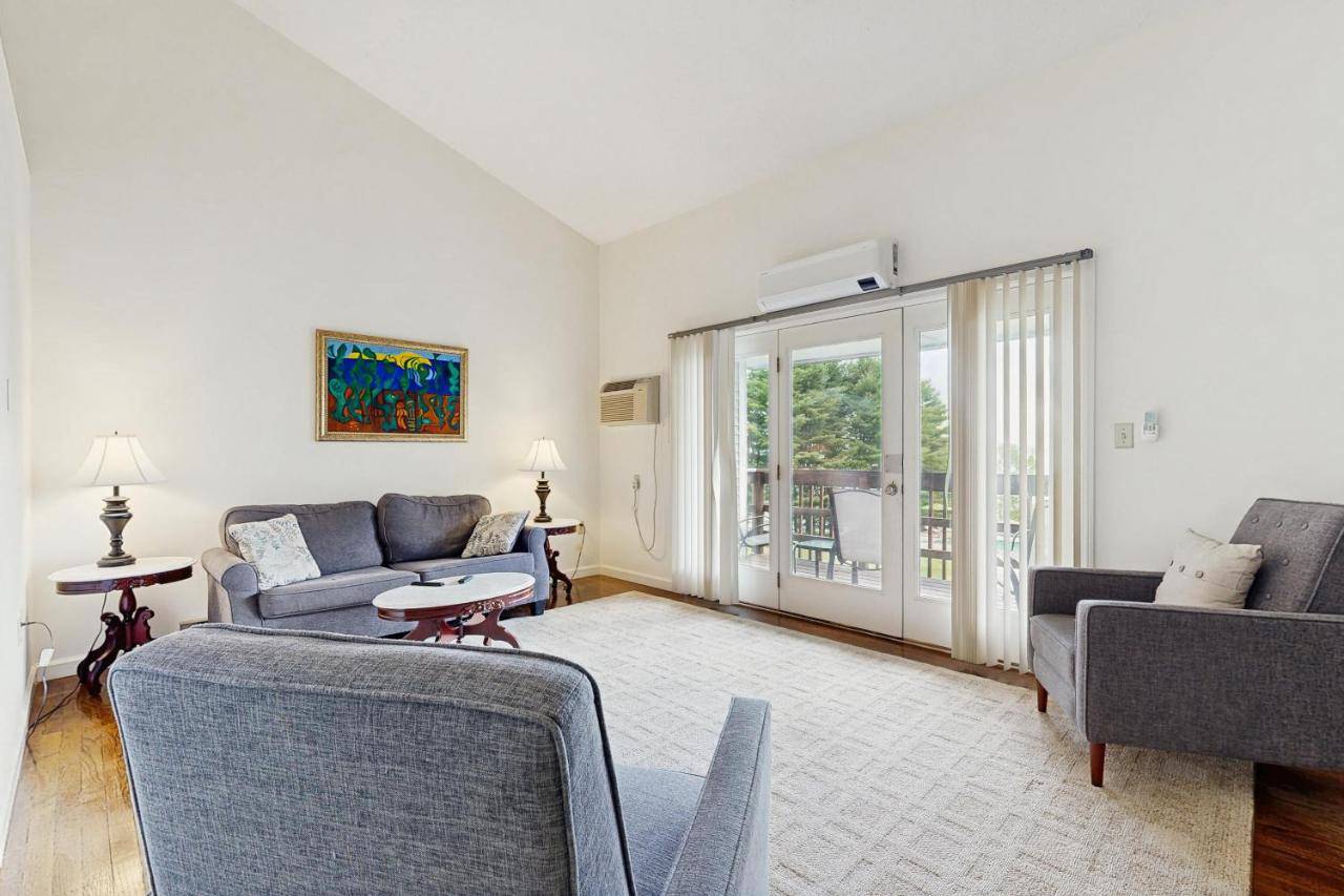 a living room with two couches and a table at Birch Tree Lane - Unit 315 in Bar Harbor