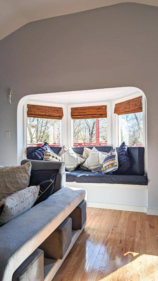a living room with blue couches and two windows at Glen Mary Apartments in Bar Harbor