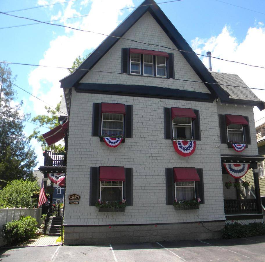 a white house with american flags on it at Hearthside Inn in Bar Harbor