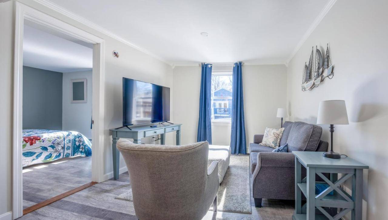 a living room with a couch and a chair at Main Street Downtown Apartments in Bar Harbor