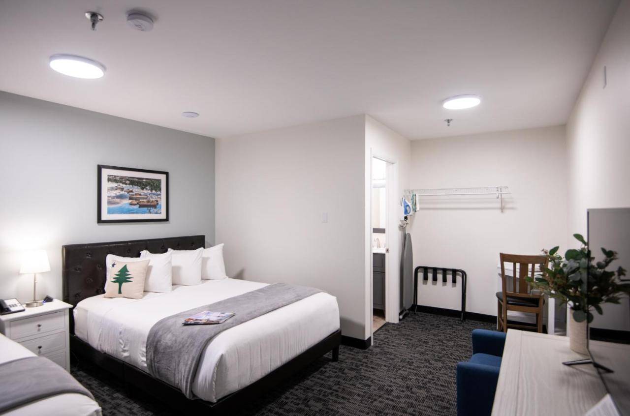 a hotel room with a bed and a couch at Main Street Motel in Bar Harbor