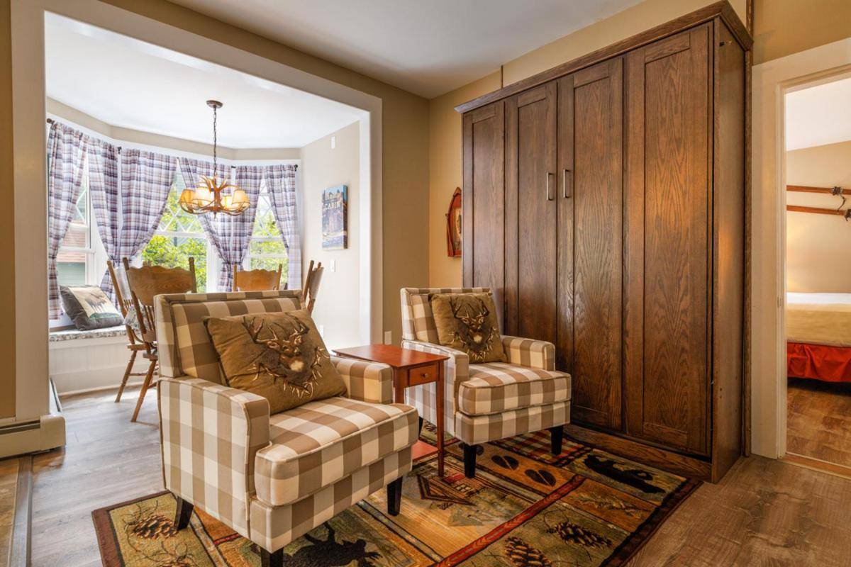 a living room with two chairs and a table at Mira Monte Inn & Suites in Bar Harbor