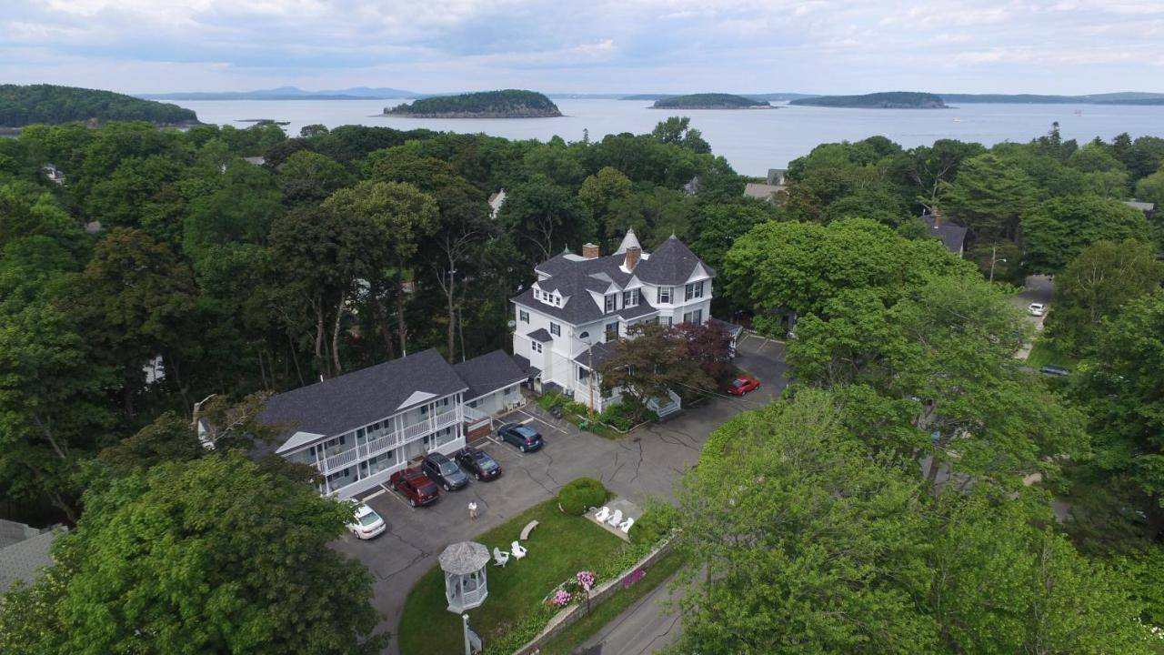 an aerial view of a large white house with trees at Moseley Cottage Inn and The Town Motel in Bar Harbor
