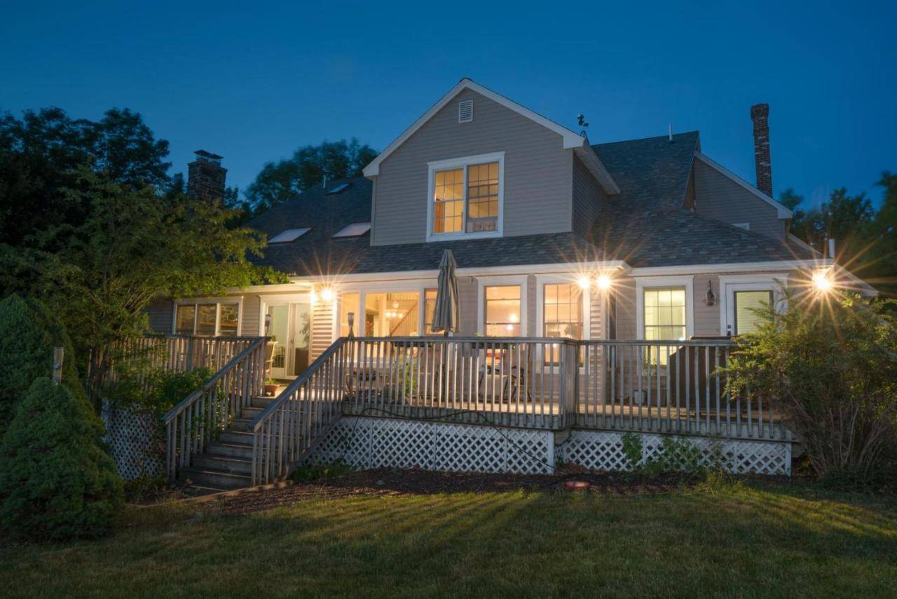 a house with lights on the front porch at night at Strawberry Hill in Bar Harbor