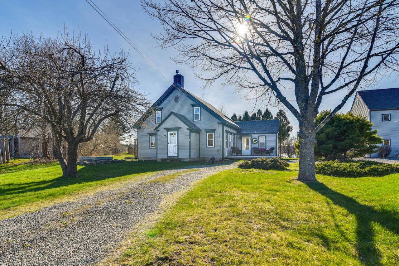a house on a gravel road next to a tree at Quiet Waterfront Home Ideal Maine Escape! in Bass Harbor