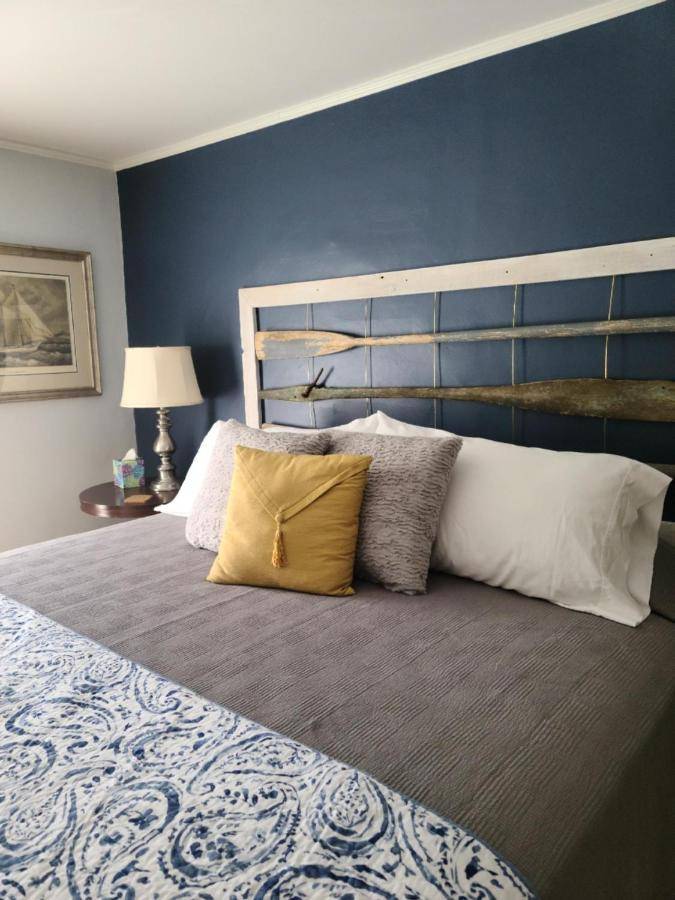 a bedroom with a large bed with a blue wall at Benjamin F. Packard House Bed and Breakfast in Bath