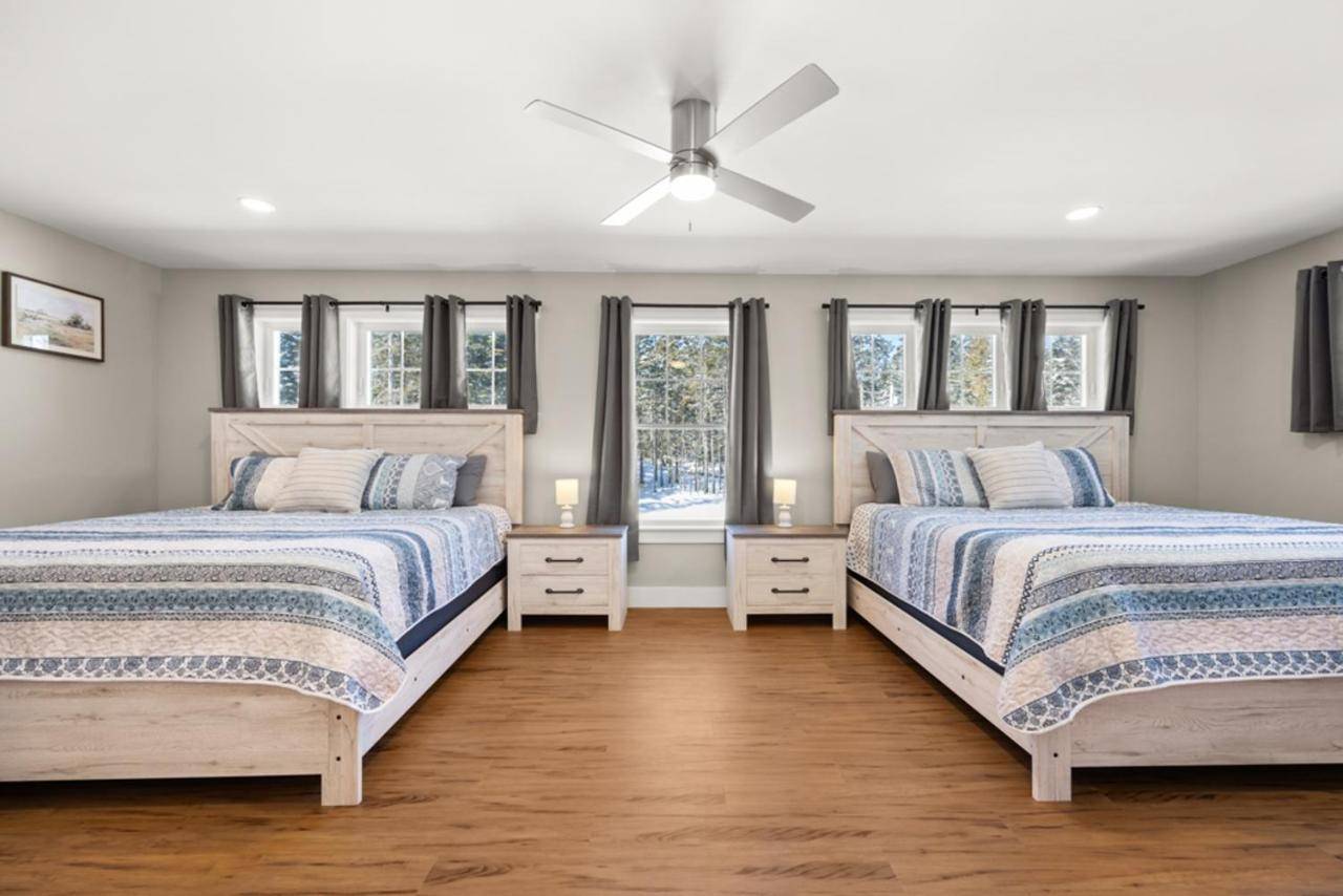 two beds in a bedroom with windows at Tide Song -10D in Bernard