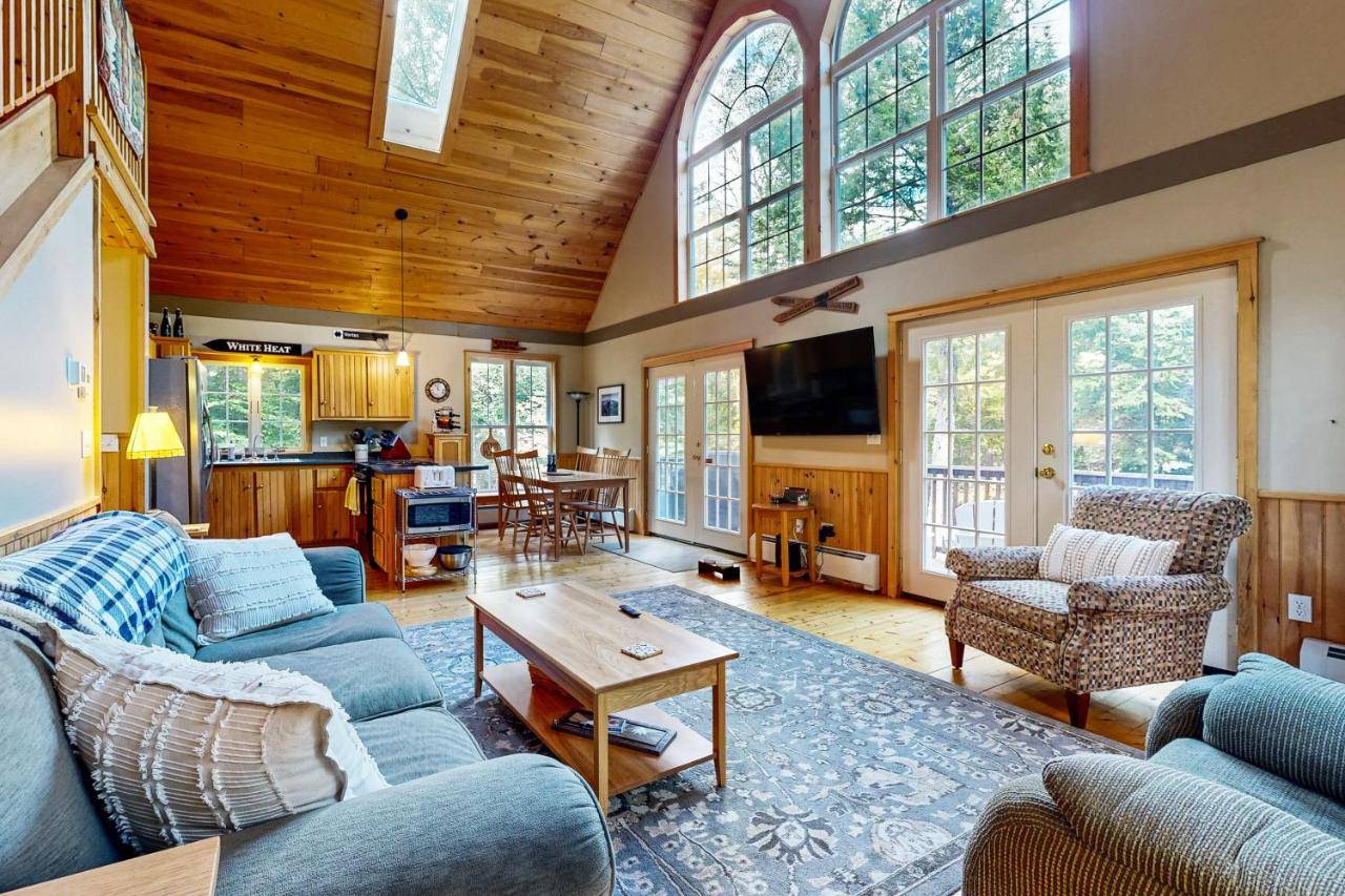 a living room with a blue couch and a table at Bethel Peak Escape in Bethel