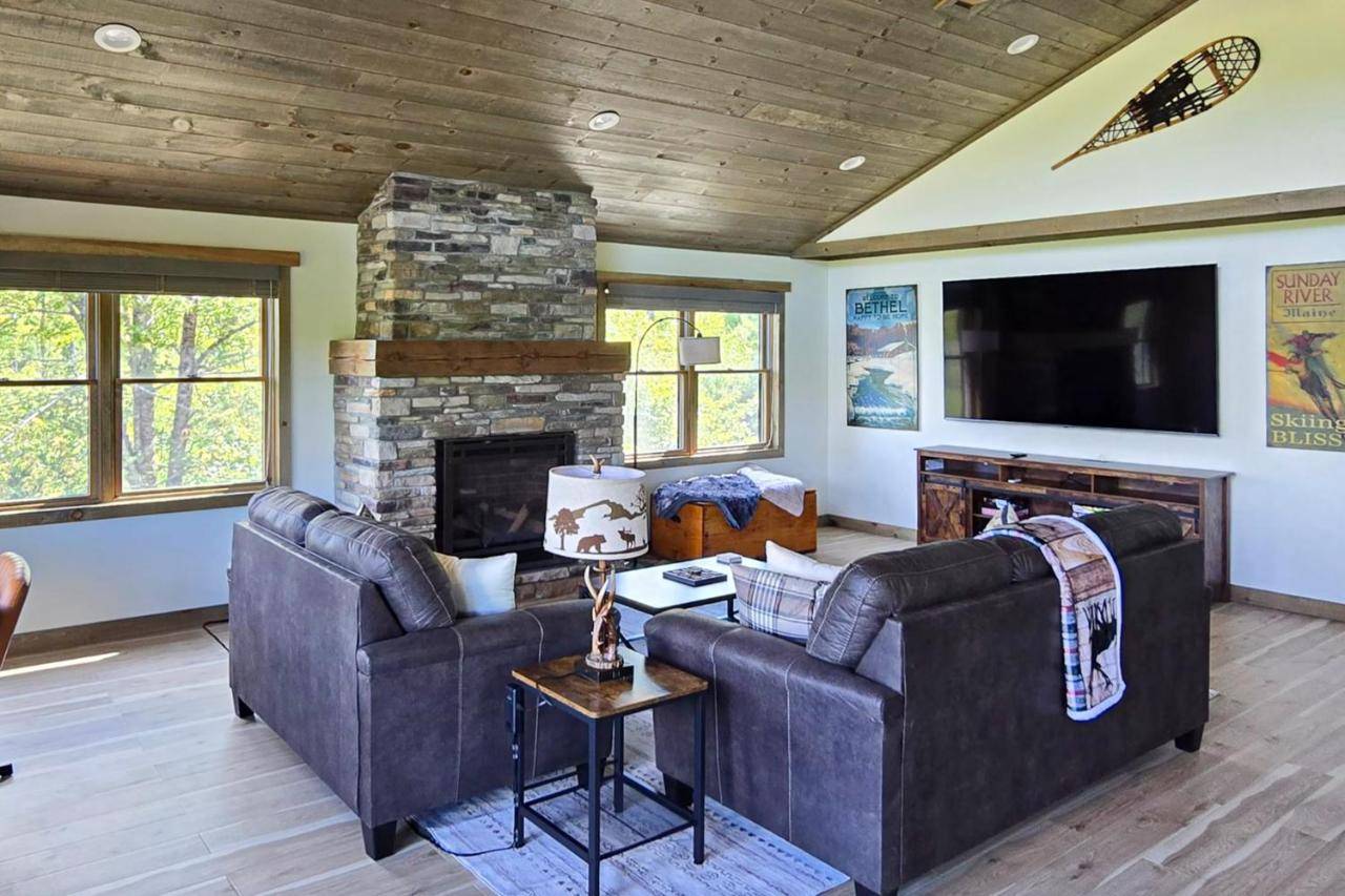 a living room with two couches and a fireplace at Brightwind Lodge in Bethel