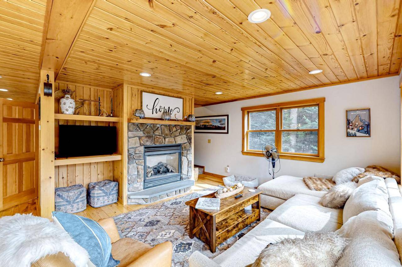 a living room with a couch and a fireplace at English Woods Enchantment in Bethel