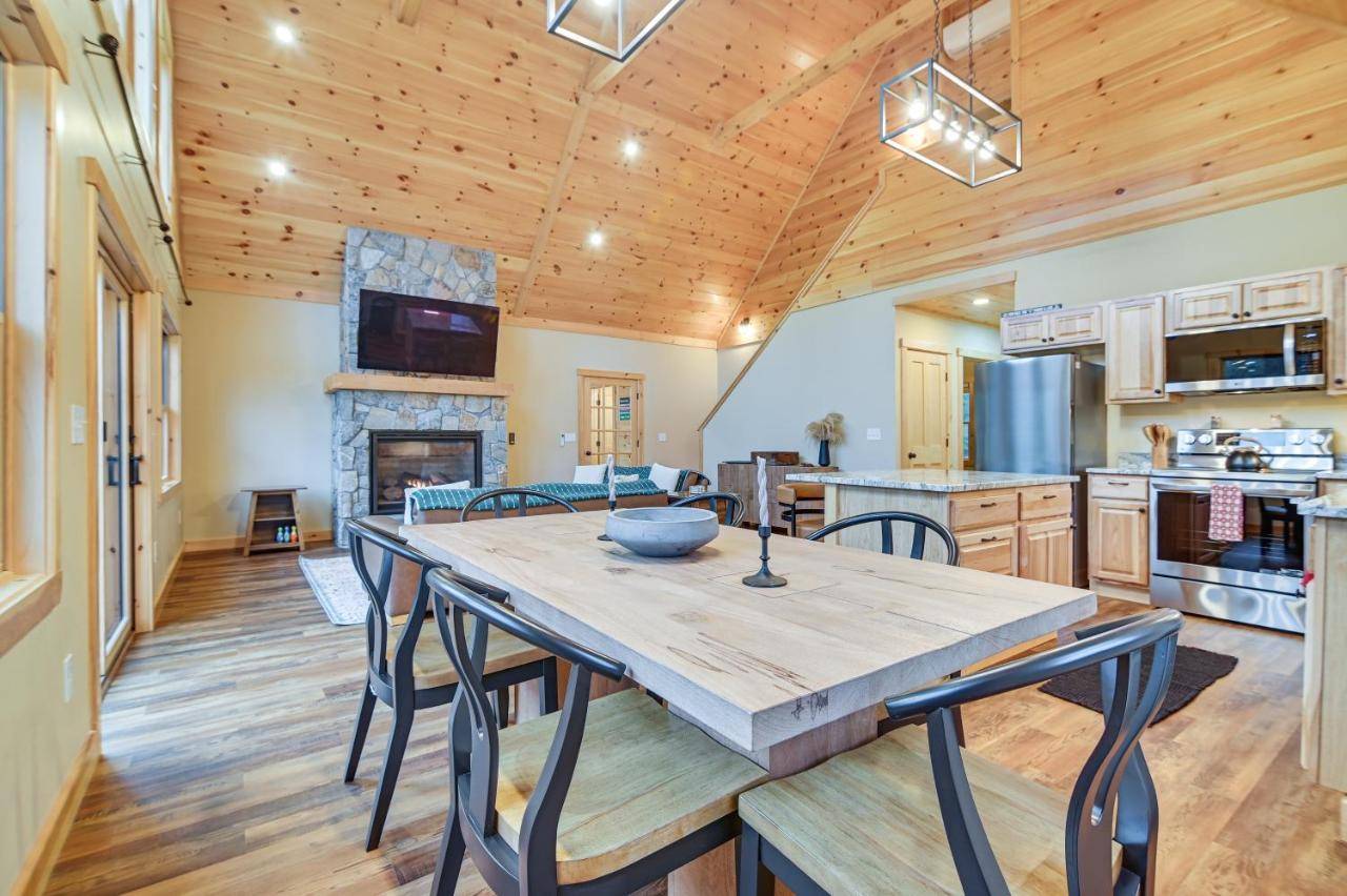 a large kitchen with a wooden table and chairs at Hot Tub | Fire Pit | Mtn Escape Near Sunday River in Bethel
