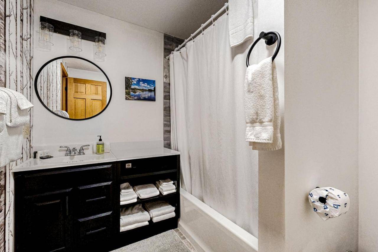 a bathroom with a sink and a mirror at Sunday River Sunny Chalet in Bethel
