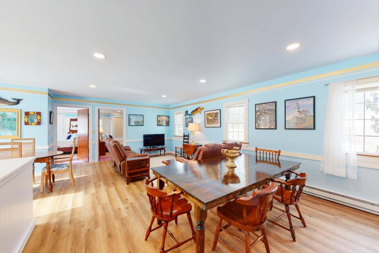 a dining room and living room with a table and chairs at Blue Lagoon Escape A&B in Boothbay