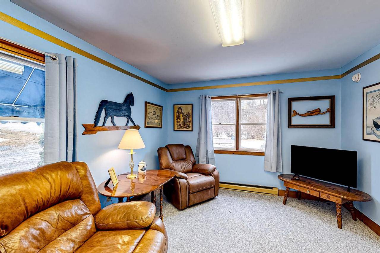 a living room with a couch and a television at Blue Lagoon Escape Unit-A in Boothbay
