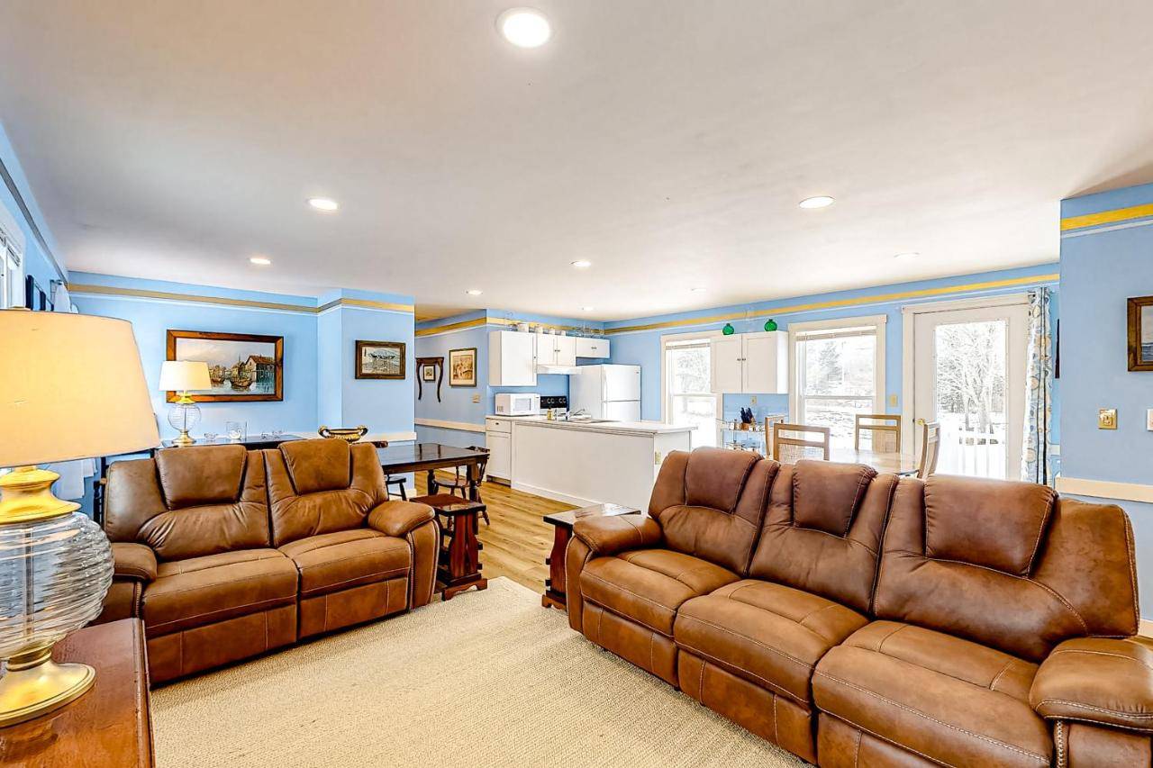 a living room with two couches and a kitchen at Blue Lagoon Escape Unit-B in Boothbay