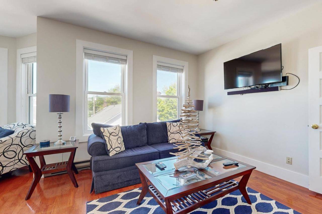 a living room with a couch and a table at Admiral's Quarters in Boothbay Harbor
