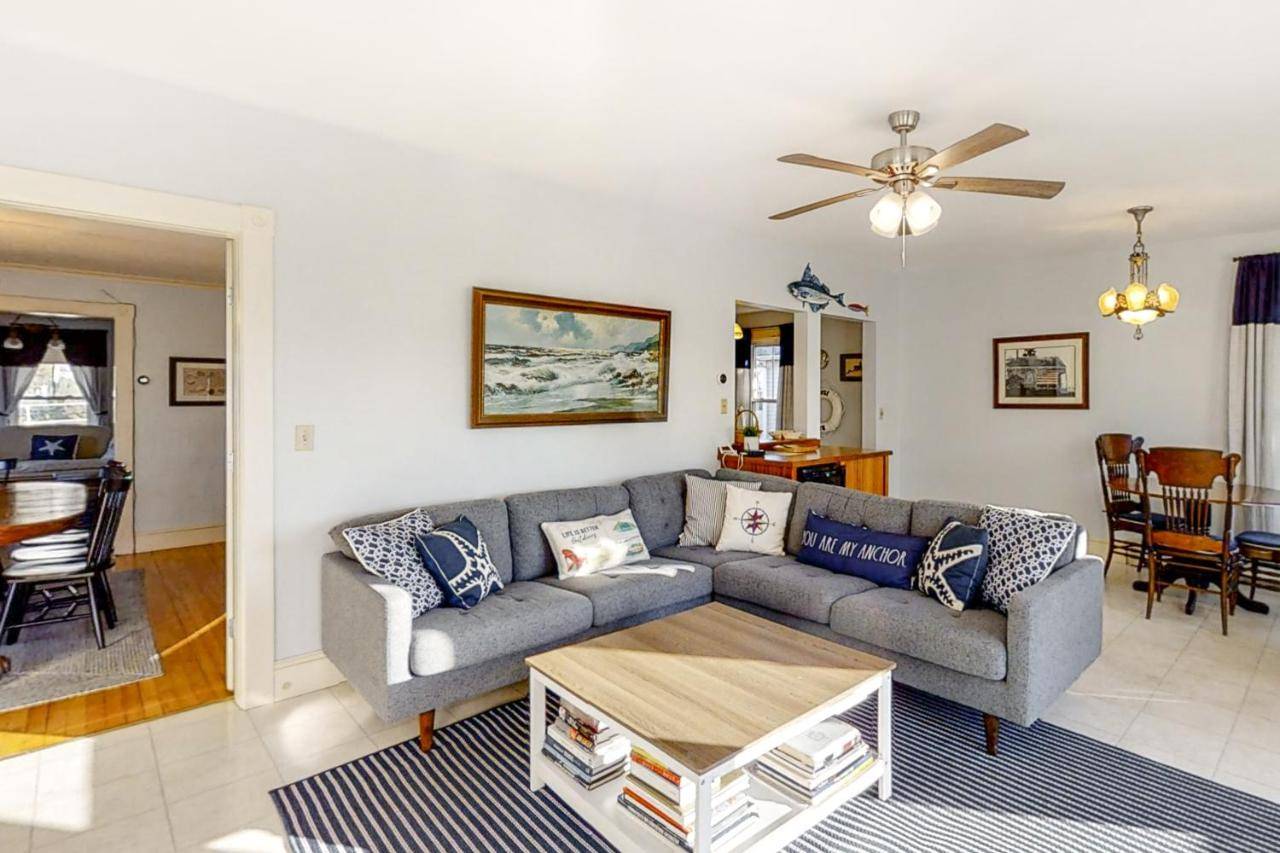 a living room with a couch and a table at Atlantic Gardens II in Boothbay Harbor