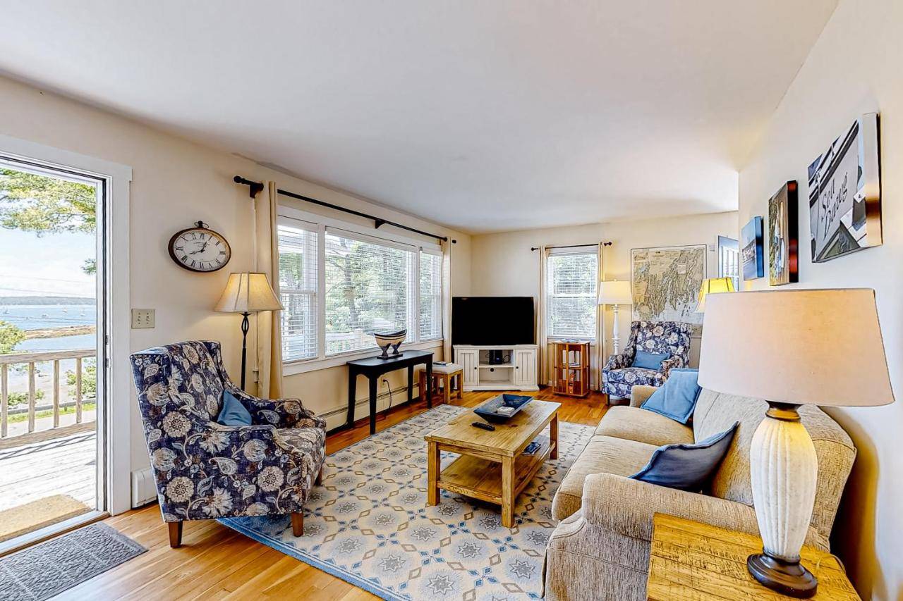 a living room with a couch and chairs and a tv at Barrett's Watch Main House in Boothbay Harbor