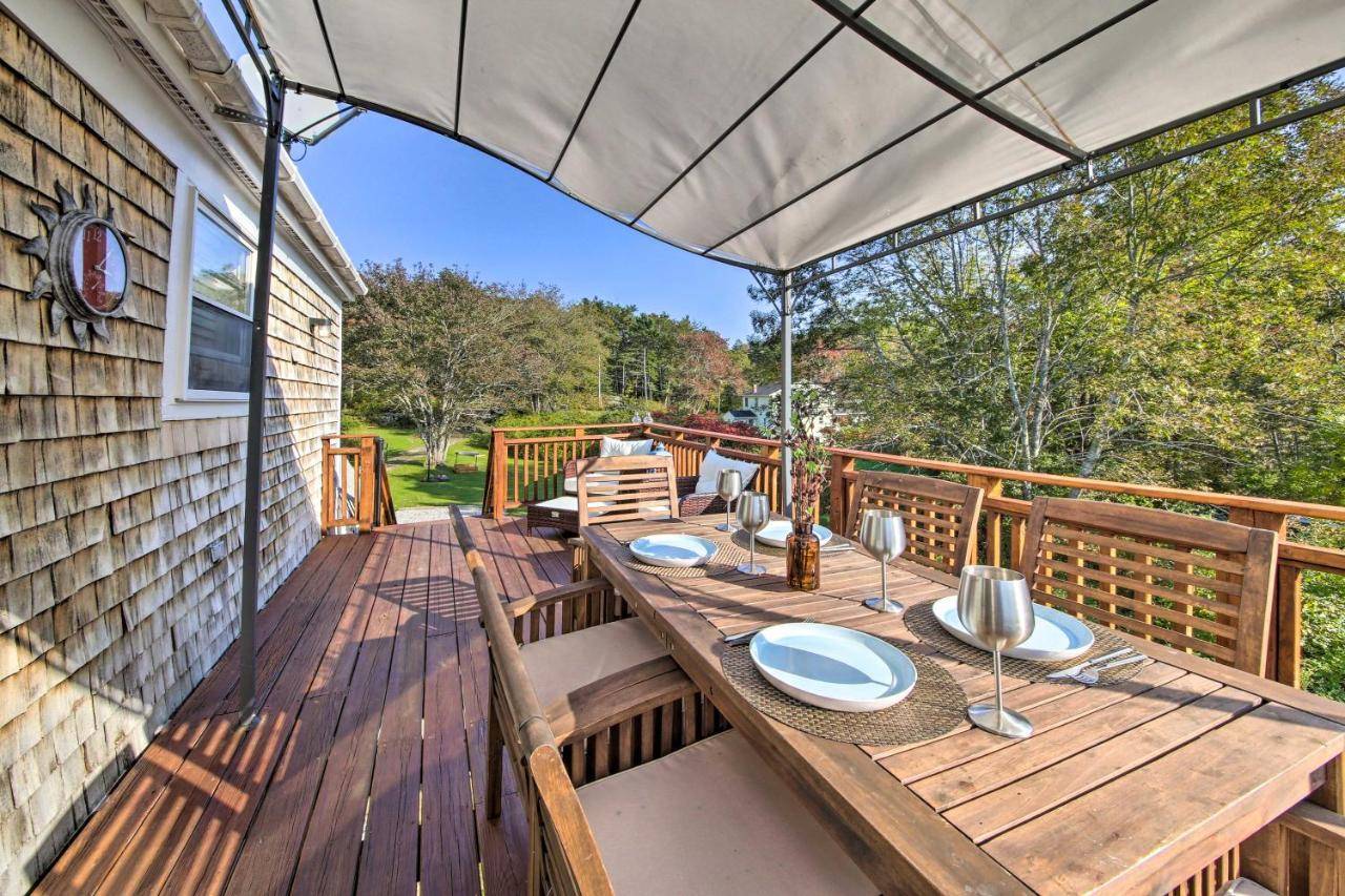 a wooden table on the deck of a house at Boothbay Apt with Furnished Deck about 1 Mi to Bay in Boothbay Harbor