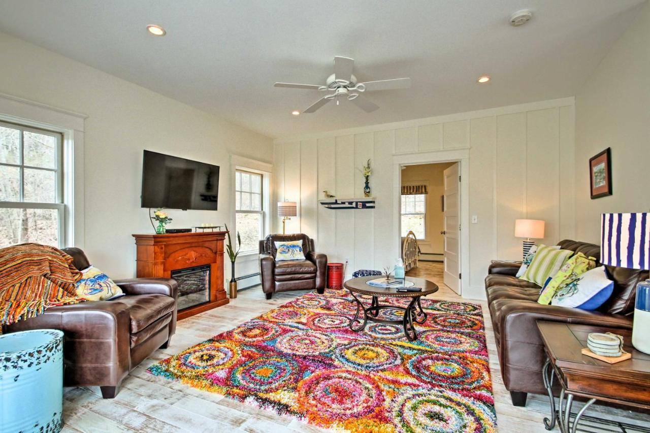 a living room with a couch and a table at Boothbay Harbor Beach House By Park and Restaurants! in Boothbay Harbor