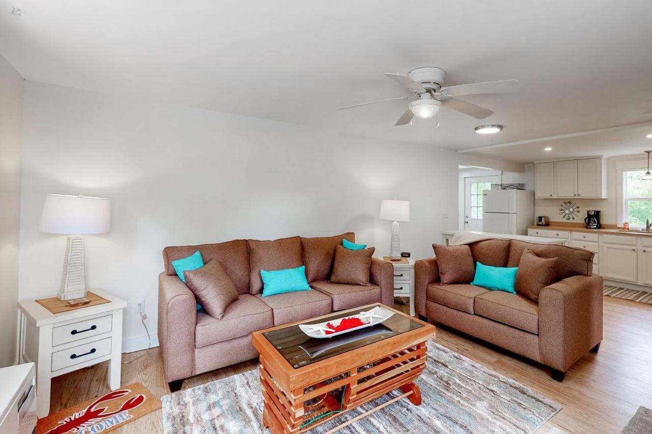 a living room with two couches and a table at Lobster Trap in Boothbay Harbor