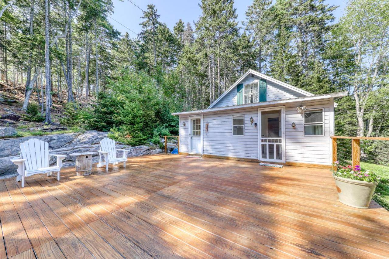 a deck with two chairs and a house at Sea View & Overlook in Boothbay Harbor