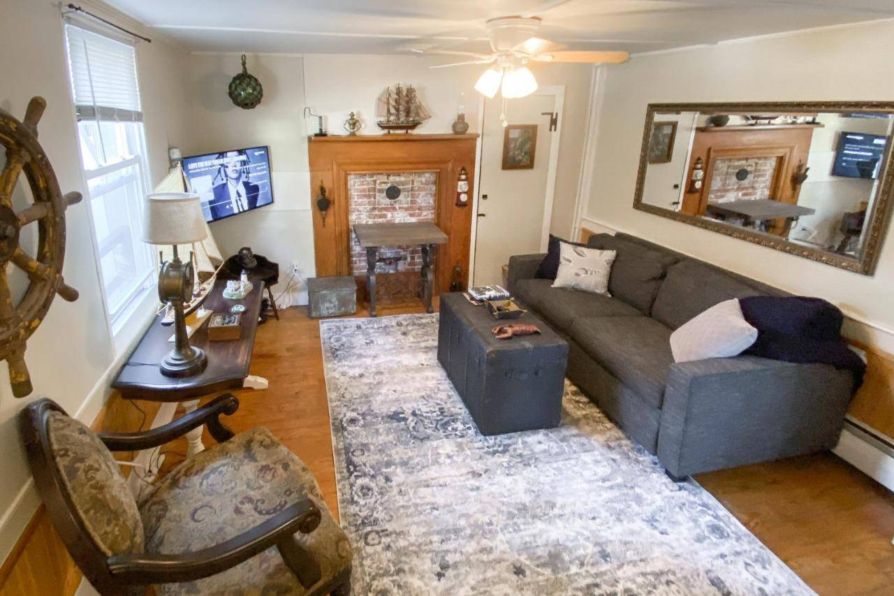 a living room with a couch and a chair at Snug Harbor I in Boothbay Harbor