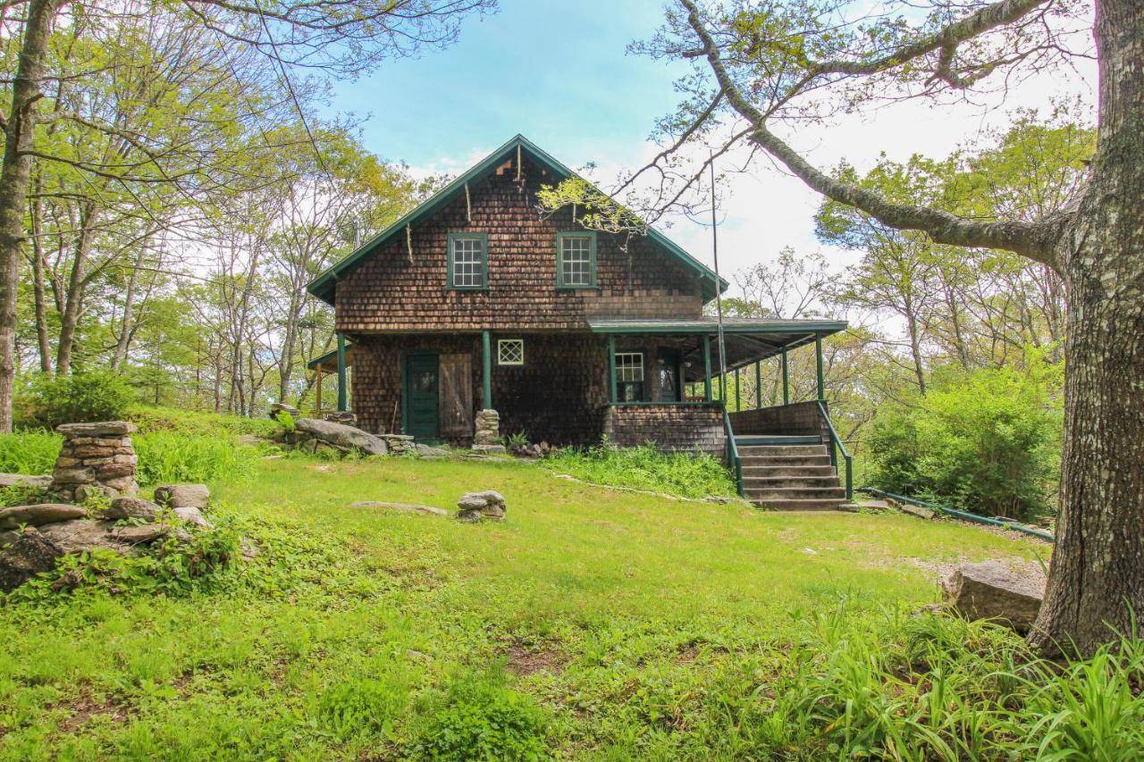 an old house in the middle of a field at The 1909 Cottage in Boothbay Harbor