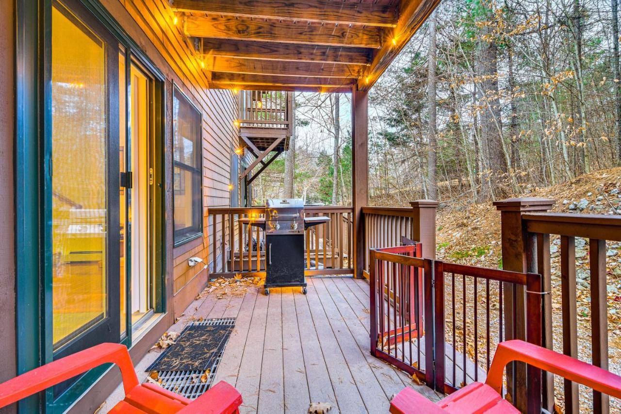 a screened porch with a grill on a house at Ski-InandSki-Out Condo at Pleasant Mountain! in Bridgton