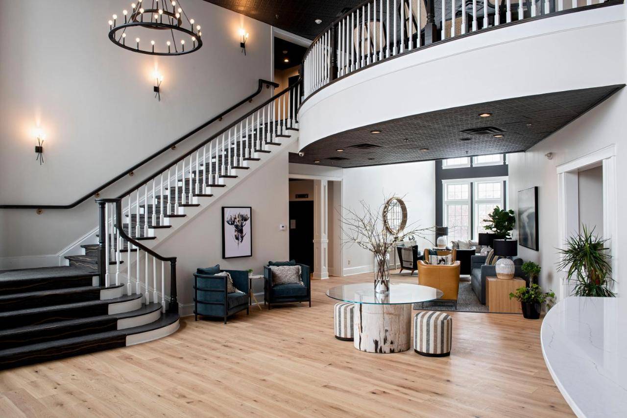 a lobby with a staircase and a table and chairs at The Federal in Brunswick